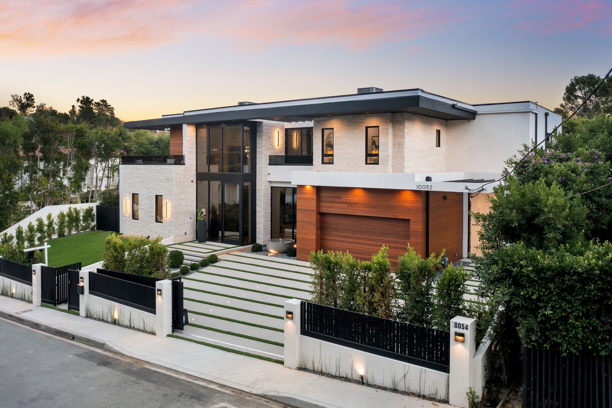 Modern luxury house exterior at sunset.